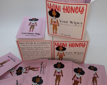 May include: A pink box with a cartoon illustration of a woman wearing pajamas and the text "Yoni Honey Yoni Wipes (Stay fresh & Confident)". The box contains 15 individual pink packets with the same illustration and the text "Yoni Honey Wipe @yonihoneyy".