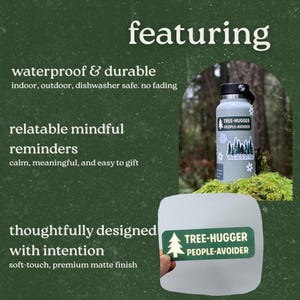 May include: A light gray water bottle with a black lid and a sticker that says "TREE-HUGGER PEOPLE-AVOIDER." The image also features a sticker with a tree graphic and the same text. The background is a forest scene.