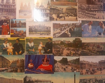 Op de afbeelding: Een verzameling vintage ansichtkaarten met verschillende Londense bezienswaardigheden, waaronder St. Paul's Cathedral, de Tower of London en koninklijke figuren. De ansichtkaarten tonen historische scènes.