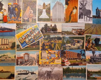 May include: A collection of vintage postcards featuring various scenes. The postcards depict buildings, landscapes, and historical figures. One postcard reads "Greetings from Detroit, Michigan."