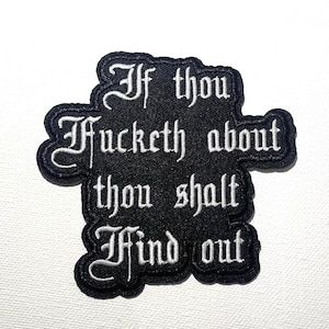 May include: Black embroidered patch with white gothic lettering. The patch reads "If thou fucketh about thou shalt find out". The patch has a black border and is likely for clothing or accessories.