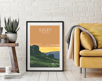 May include: A framed print of a landscape scene with a sunset over a rocky hill. The print is titled "ILKLEY COW & CALF" in a white font on a peach background.