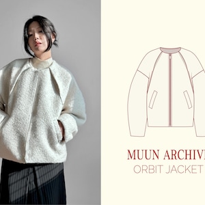May include: A woman in a cream-coloured, textured jacket with a zip closure and pockets, paired with black and grey striped trousers. The image also features a line drawing of the jacket with the text "MUUN ARCHIVE ORBIT JACKET."
