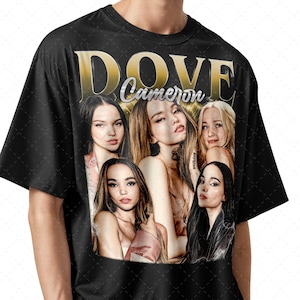 May include: Black t-shirt featuring a graphic of Dove Cameron with the text "DOVE Cameron" in gold lettering. The graphic includes multiple images of Dove Cameron. The shirt is made of a soft, comfortable material.
