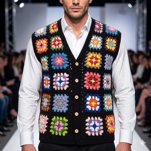 May include: A sleeveless V-neck vest made of black yarn featuring a colorful granny square pattern. The garment is constructed with multiple crocheted squares in shades of pink, yellow, blue, and green, and it fastens with five light-colored buttons.