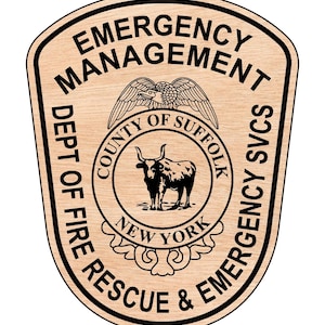 May include: Wooden plaque with a black border featuring the text "EMERGENCY MANAGEMENT" and "DEPT OF FIRE RESCUE & EMERGENCY SVCS". A circular emblem in the center displays a bull and the words "COUNTY OF SUFFOLK NEW YORK".