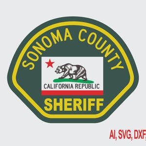 May include: A dark green shield-shaped emblem with a yellow border featuring the text SONOMA COUNTY and SHERIFF in yellow. In the center is a white rectangle with a red star, a black bear, and the text CALIFORNIA REPUBLIC in black and red.