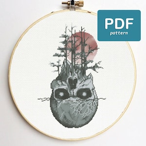 May include: Cross stitch pattern featuring a skull with trees growing out of the top, a red sun in the background, and the text "PDF pattern".
