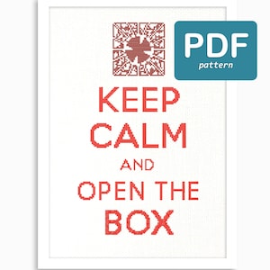 May include: A white framed cross-stitch pattern with red text that reads "Keep Calm and Open the Box". The pattern is a PDF download.