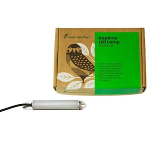 May include: A brown cardboard box with a green label that says "Daytime LED Lamp for bird boxes". The box features a picture of an owl. The label also includes text describing the product. A white LED light with a black wire is shown in the foreground.