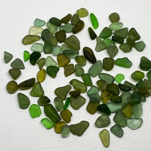 May include: A collection of green, blue and yellow sea glass pieces. The sea glass is smooth and has been tumbled by the ocean.