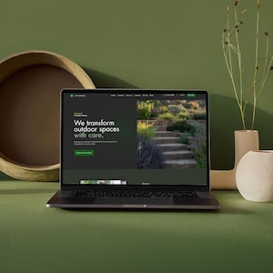Laptop mockup displaying a landscaping Wix website template on a green styled background.