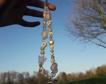 Perlas blancas y colgante transparente para el teléfono