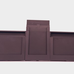 May include: A three-piece brown battery pack for a laptop computer.