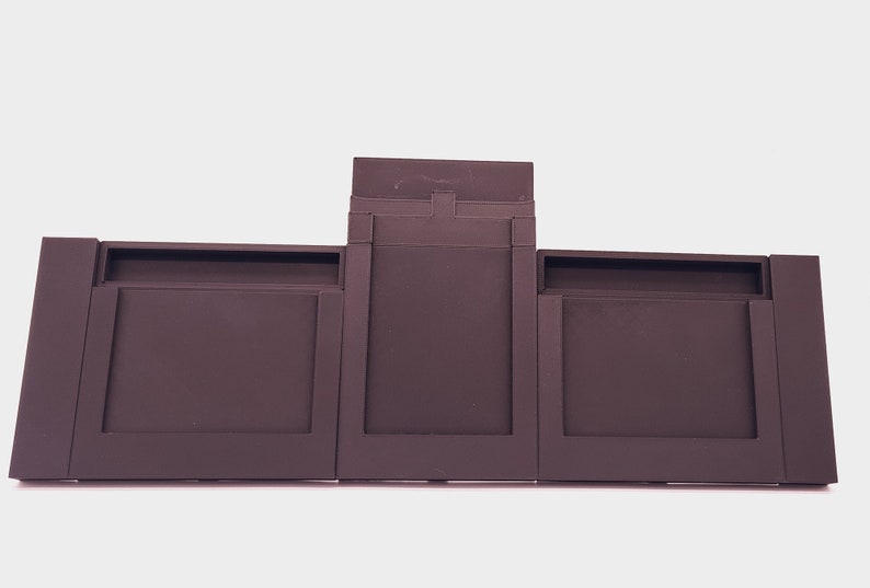 May include: A three-piece brown battery pack for a laptop computer.