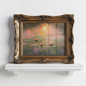 May include: A framed painting with a gold-coloured ornate frame, depicting water lilies. The artwork shows pink water lilies and lily pads on the water, with a sunset reflected. The frame has a detailed, vintage design, and the painting is on display.