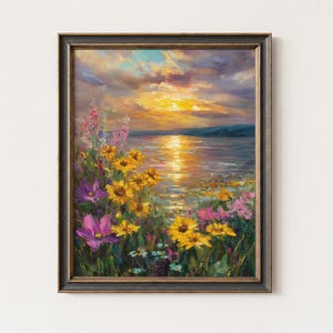 May include: Framed landscape oil painting depicting a sunset over a body of water. The artwork features vibrant yellow, purple, and pink wildflowers in the foreground, with a golden sun reflecting on the water. The frame is dark with gold accents.