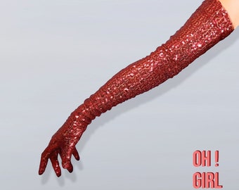 May include: A red sequined long glove with the text "OH! GIRL GANG" in pink.