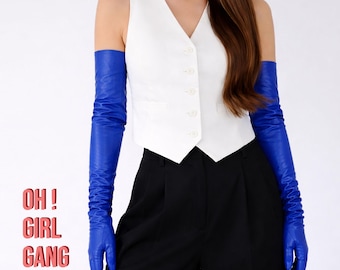 May include: A white sleeveless vest with five buttons and two front pockets, paired with black trousers and long, bright blue opera-length gloves. The text OH ! GIRL GANG is printed in red on the left side of the image.