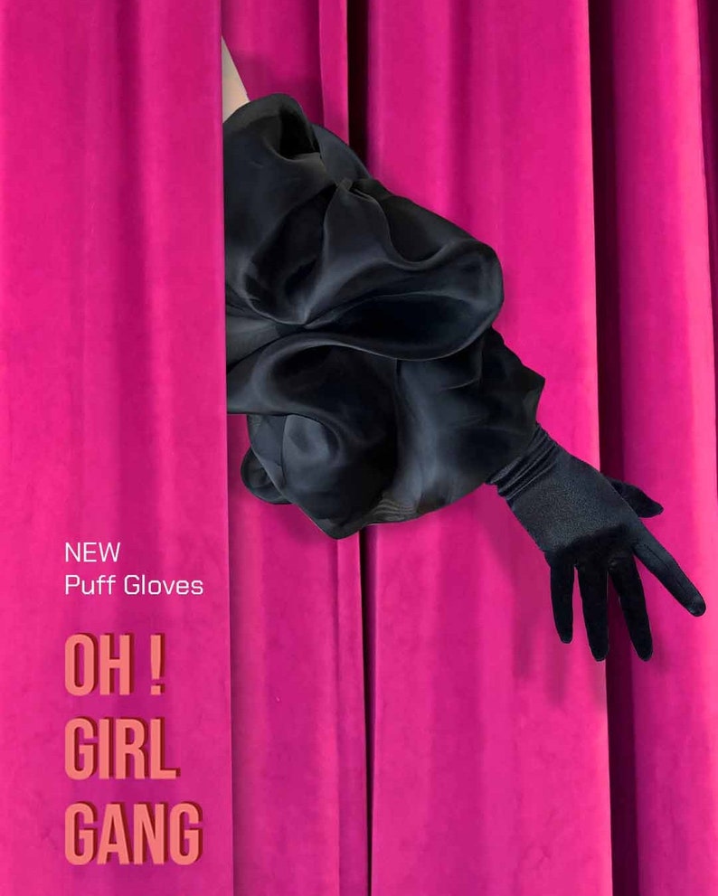 May include: A black puff sleeve with a black long glove peeking out from behind a bright pink curtain. The text "NEW Puff Gloves OH! GIRL GANG" is printed on the curtain.