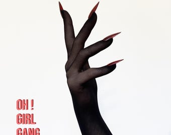 May include: A sheer black glove covering the hand and forearm, featuring long, pointed, dark red fingernails. The text "OH ! GIRL GANG" is printed in a bold, coral-red sans-serif font on the lower left side of the image against a plain white background.