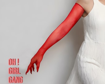 Puede incluir: Una manga y un guante rojos transparentes. El texto "OH! GIRL GANG" está impreso en un color rojo rosado en el lado izquierdo de la imagen. La manga se usa con un vestido blanco.