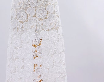 May include: White lace fabric with a floral pattern. The lace is delicate and intricate, with a soft, flowing texture.