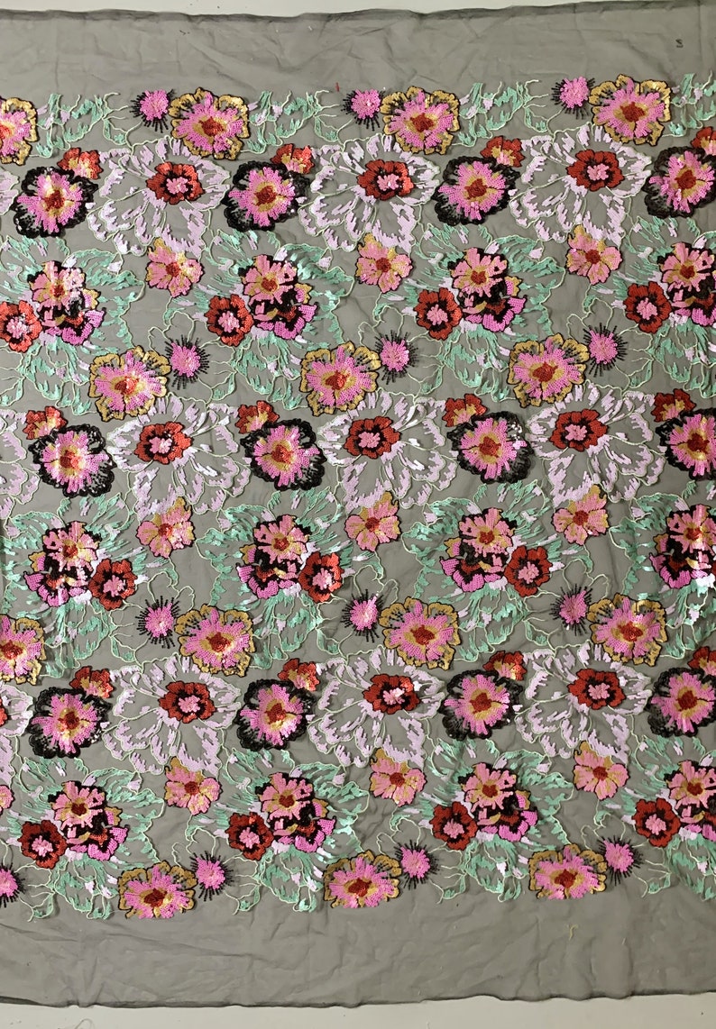 Puede incluir: Tela bordada con flores con lentejuelas en tonos de rosa, rojo, verde, dorado y negro sobre un fondo de malla transparente.