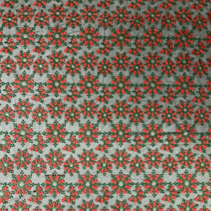 May include: Black mesh fabric with a repeating pattern of red and green embroidered snowflakes.