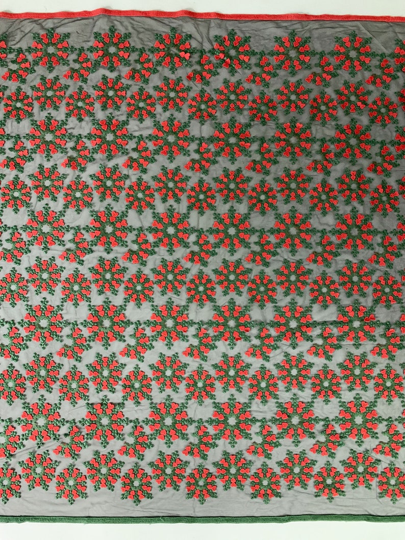 May include: Black mesh fabric with a repeating pattern of red and green embroidered snowflakes.