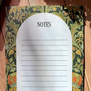 May include: A green and gold floral patterned notepad with a white lined section for writing notes. The section is labeled "NOTES" at the top.