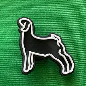 May include: Black and white outline of a goat, the goat is facing left, the outline is white and the inside is black.