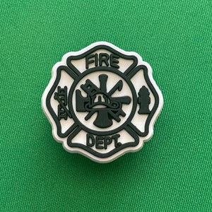 May include: White and black fire department emblem with the words "FIRE DEPT" in a circle.