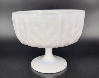 May include: A white milk glass bowl with a pedestal base. The bowl has a textured design of leaves.