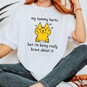 My Tummy Hurts But I'm Brave T Shirt, Funny Meme Tee, Cartoon Cat, Kawaii Animal Shirt, Weirdcore Clothing, Oddly Specific, Chronic Illness