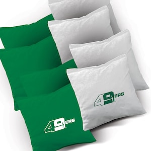 May include: Set of green and white bean bags with the San Francisco 49ers logo. The bean bags are perfect for playing cornhole or other games.