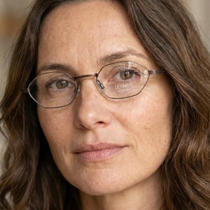 May include: A white ceramic mug with a black handle and the text "But First, Coffee" in a bold, black font. The mug is set against a neutral background, highlighting its simple design. The mug is approximately 10 cm tall.