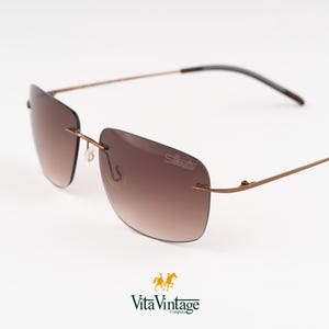 Montures vintage en titane Silhouette S8677 - Cadeau lunettes de soleil sans monture brun cuivré des années 2000 pour homme - Neuf ancien stock
