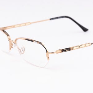 Lunettes de vue Cazal 464 vintage - Cadre rectangulaire semi-sans monture noir et or des années 90 pour femme et homme - Neuf vieux stock