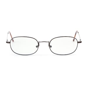 May include: Oval-shaped eyeglasses with a dark brown metal frame. The lenses are clear, and the temples are a lighter brown color. The glasses are designed for vision correction and are suitable for everyday use.