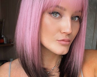 Pink purple ombre short synthetic wig with bangs and dark roots. Available only in 12 inches long.
