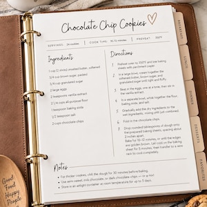 May include: A white recipe page titled Chocolate Chip Cookies inside a brown leather binder. The page lists ingredients and directions, including preheating to 350°F, with sections for breakfast, lunch, dinner, desserts, and favourites on the side.