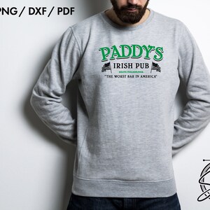 May include: A gray sweatshirt with a green and black graphic design that reads "Paddy's Irish Pub South Philadelphia "The Worst Bar in America".