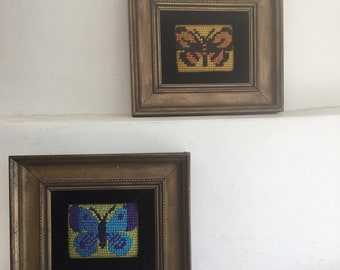 Pair of small framed needlework butterflies.  Vintage pair of needlework butterflies.  Small needlework butterfly wall hangings.