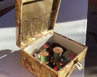 60s quilted sewing box.  Vintage sewing box with period buttons, buckle, thread.