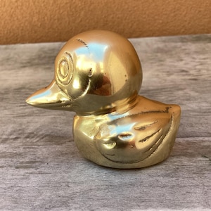 Small brass duck figurine.  Small vintage brass duck figurine/paperweight/shelf decor.