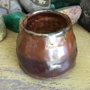 Organic Raku pottery vase.  Small organic shaped studio pottery vase/pot with metallic Raku fired glaze.