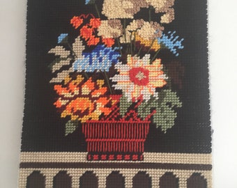 Vintage handmade needlepoint piece on plastic frame.  Colorful vintage needlepoint bouquet of flowers.