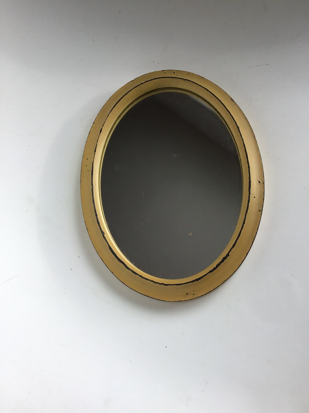 Small Oval Mirror in Mustard Colored Plastic Frame. Somewhat Distressed