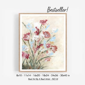 May include: A framed floral art print featuring a bouquet of flowers in shades of red, white, and blue. The painting has a textured, impressionistic style. The print is available in various sizes, from 8x10 inches to 30x40 inches. Text reads "Bestseller!" and "Real Art By A Real Artist - NO AI".